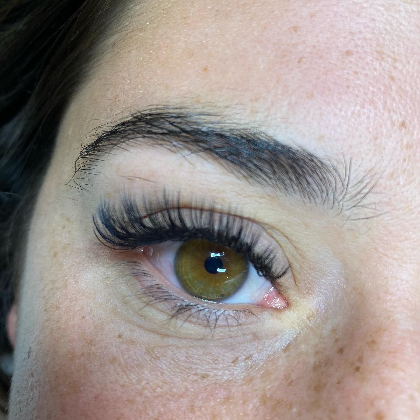 Natural lash set on freckled skin